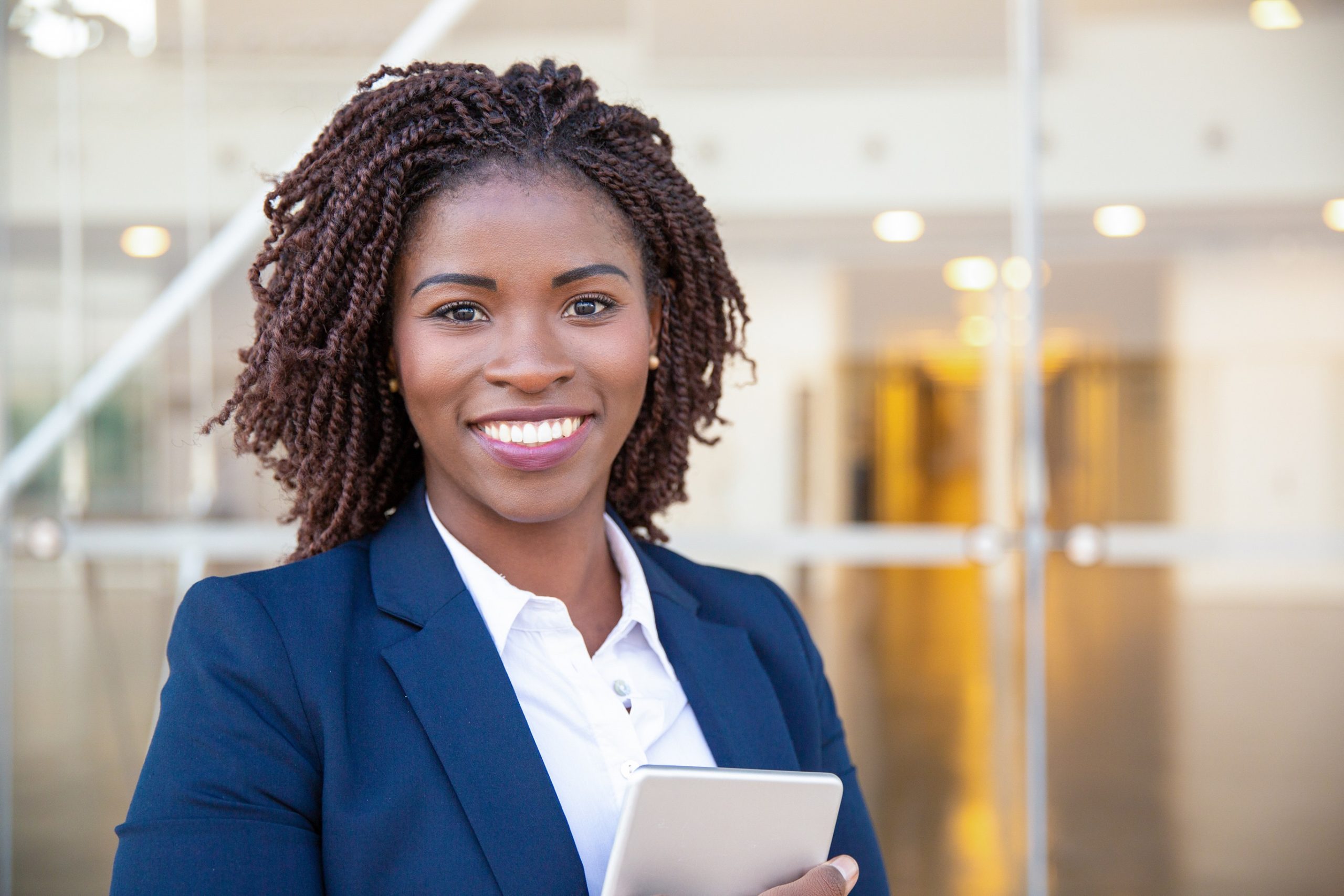 Happy joyful manager with tablet posing outside Happy joyful manager with tablet posing outside. Young African American business woman holding and embracing digital device, looking at camera, smiling. Gadget user concept